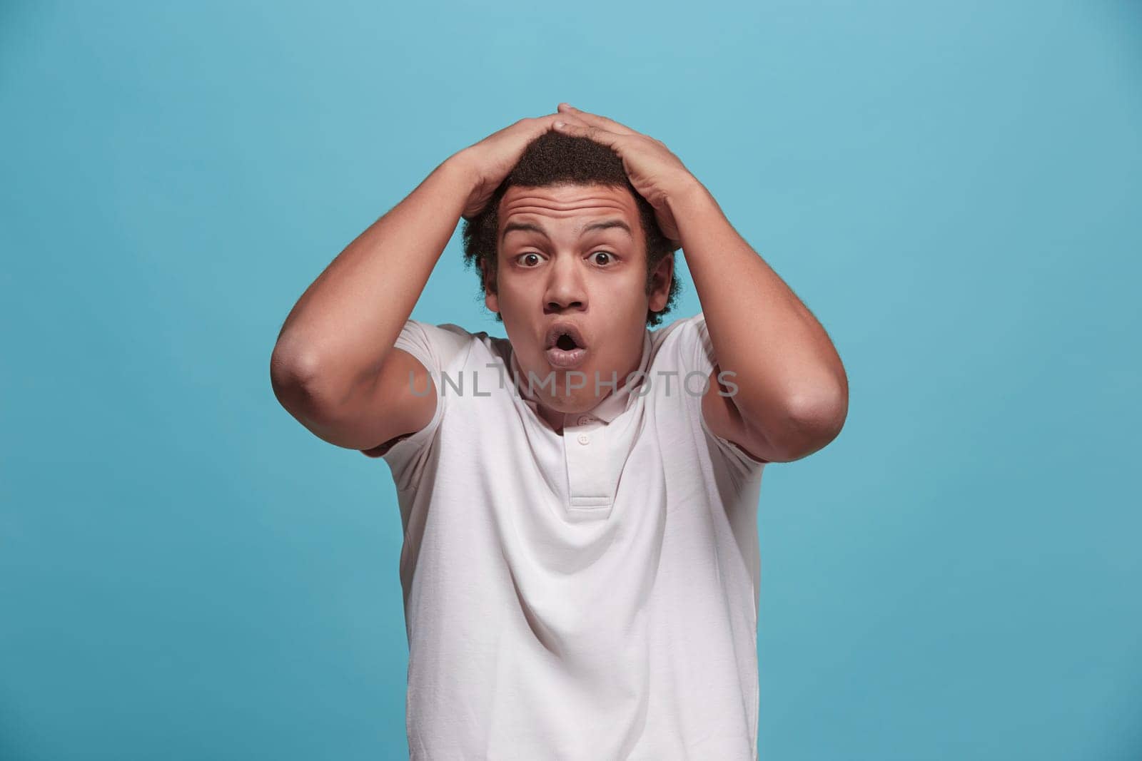Wow. Attractive male half-length front portrait on pink studio backgroud. Young emotional surprised bearded man standing with open mouth. Human emotions, facial expression concept. Trendy colors