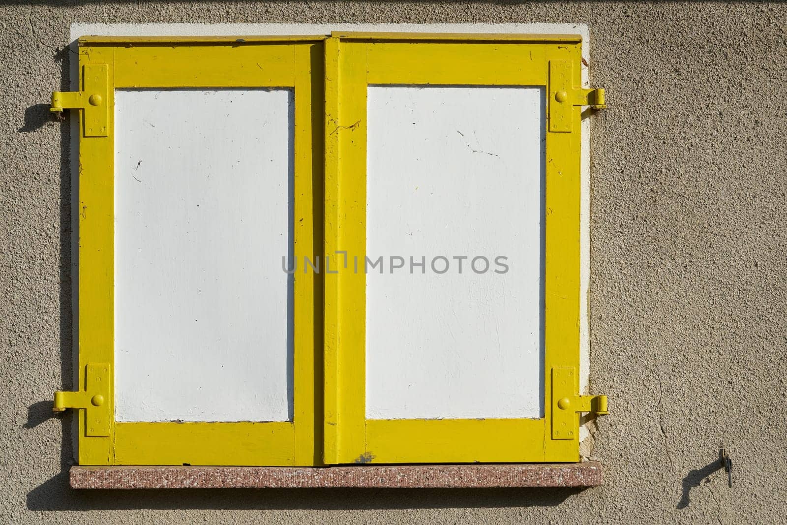 yellow shutters on the window of a house in the city center of Magdeburg