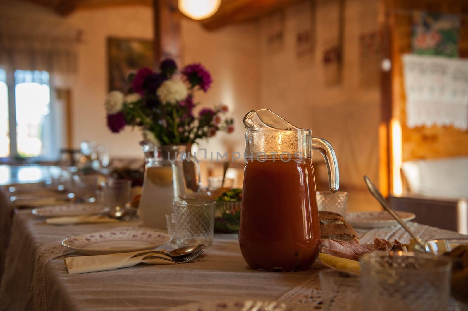 Decorated table with jug of juice on foreground