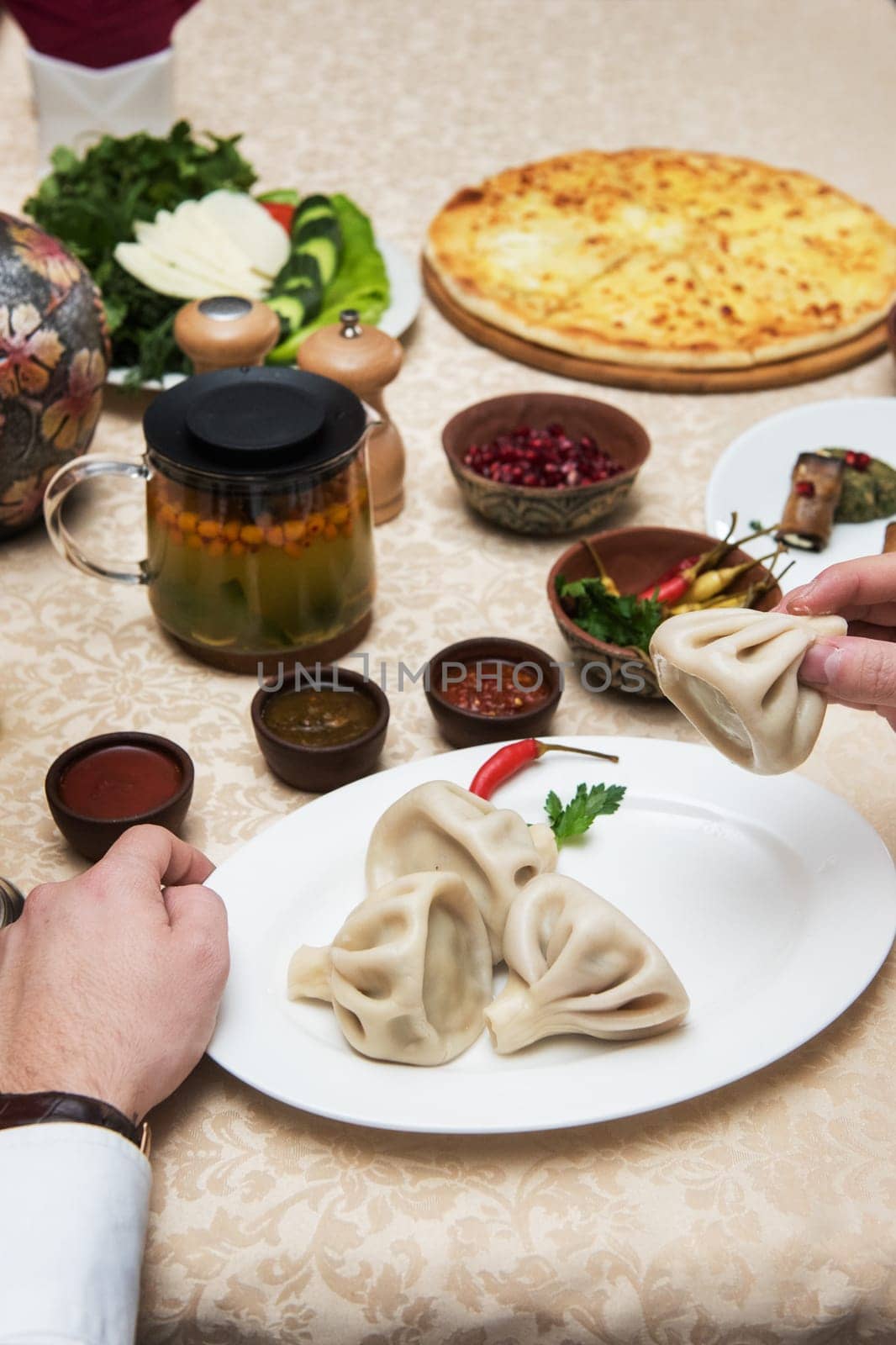 Man eating in georgian restaurant with national dishes, pov view