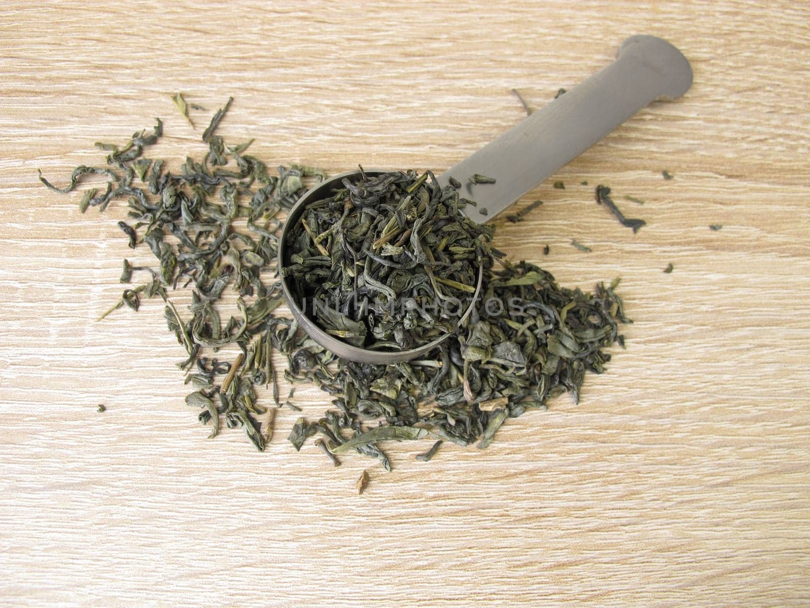 Green tea Chun Mee in tea measure