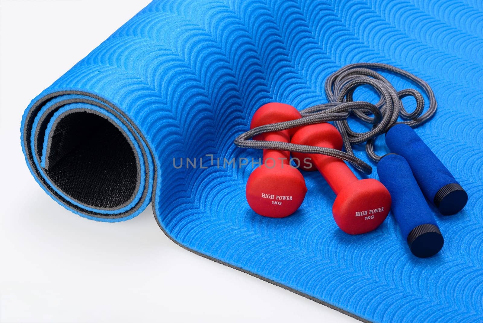 Sports fitness accessories on blue training mat. Frame, healthy.