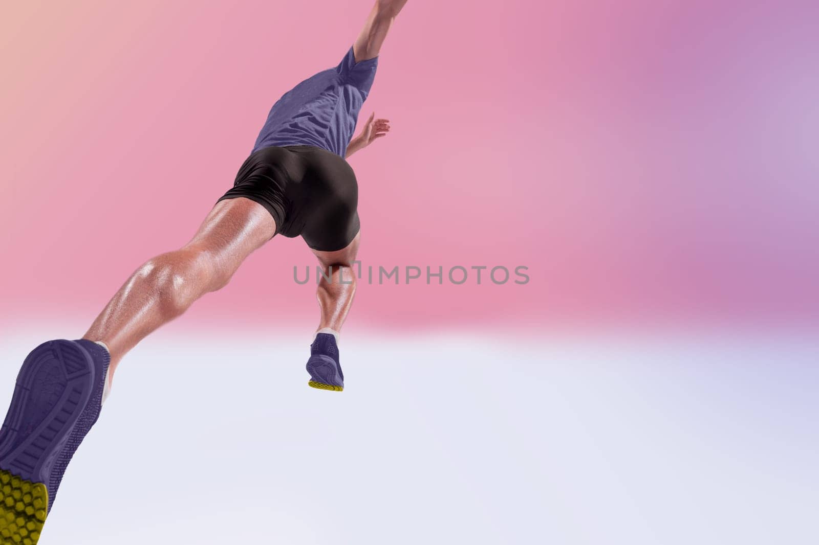 The studio shot of high jump athlete is in action on pink background