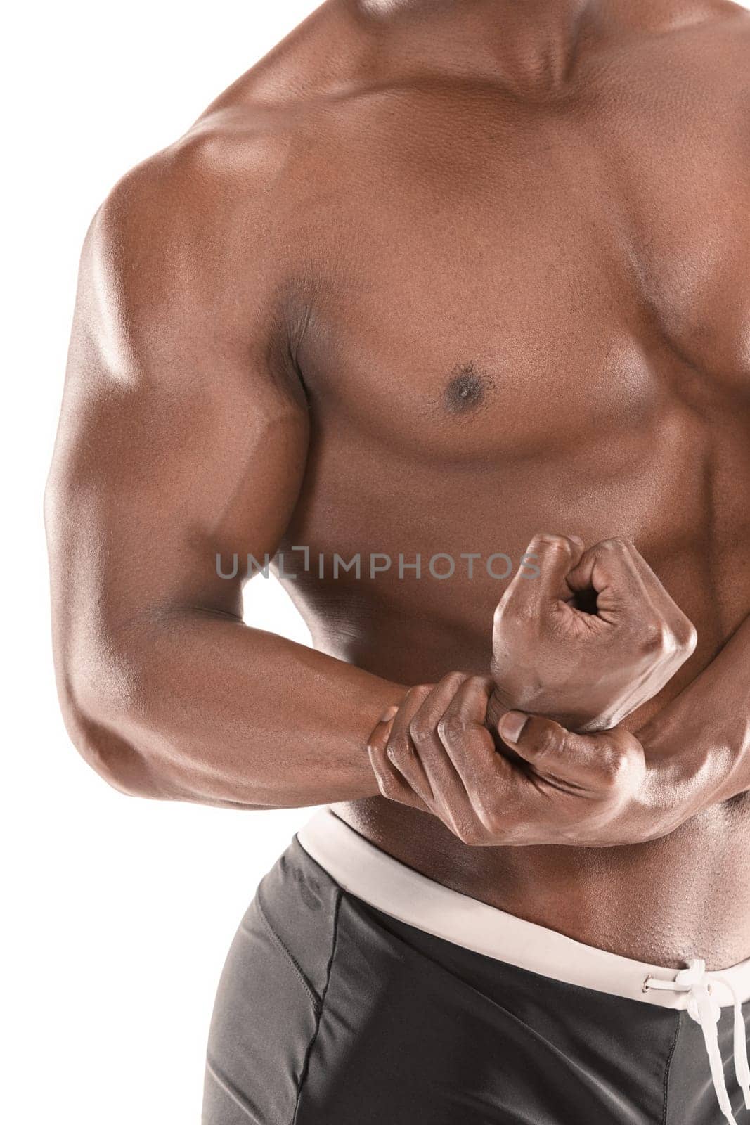 Fit young man with beautiful torso, isolated on white background. The naked torso of African American man posing at studio. The muscular body, fitness, sports, healthy lifestyle and bodybuilder concept.