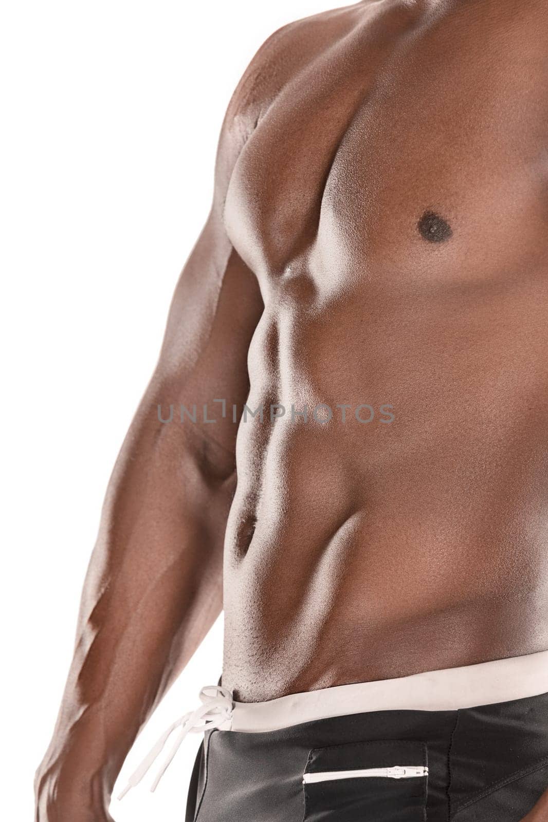 Fit young man with beautiful torso, isolated on white background. The naked torso of African American man posing at studio. The muscular body, fitness, sports, healthy lifestyle and bodybuilder concept.
