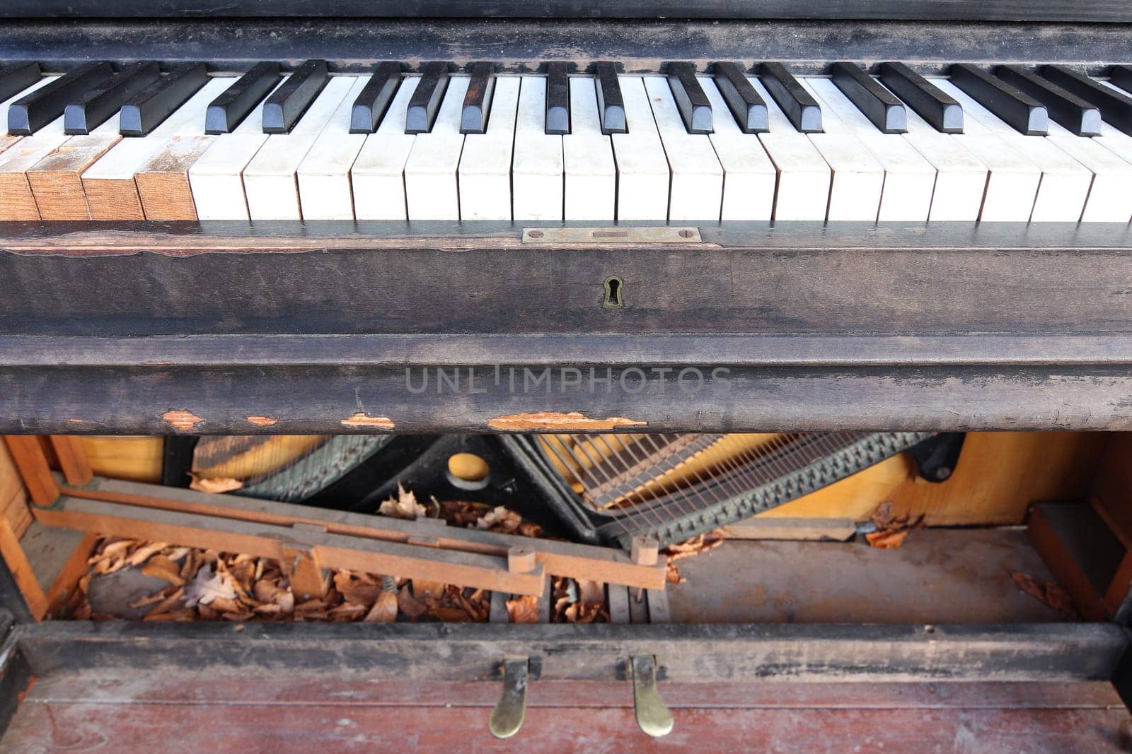 Old, broken and abandoned piano