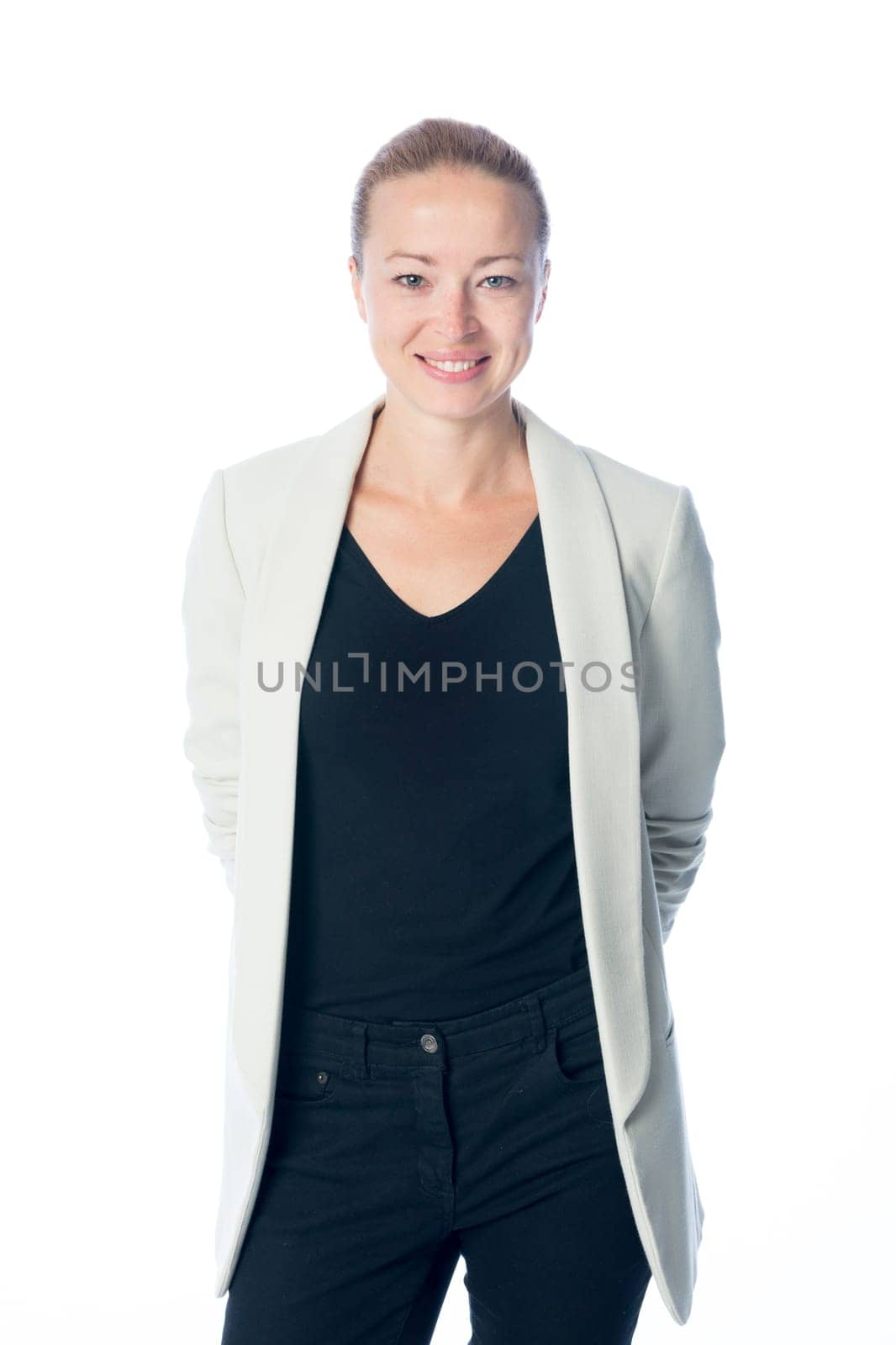Portrait of casualy dressed,cheerful, beautiful, smart, young businesswoman in standing against white background.