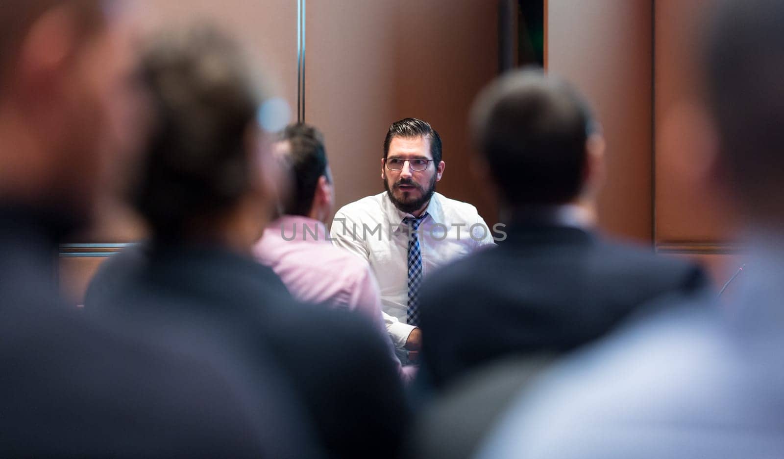 Skiled businessman presenting project to his work team at informal company business training meeting. Business people in the conference room. Business and Entrepreneurship concept.