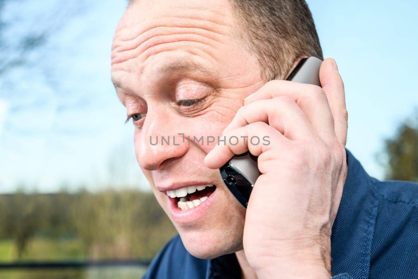 man calling with green phone in front of white background
