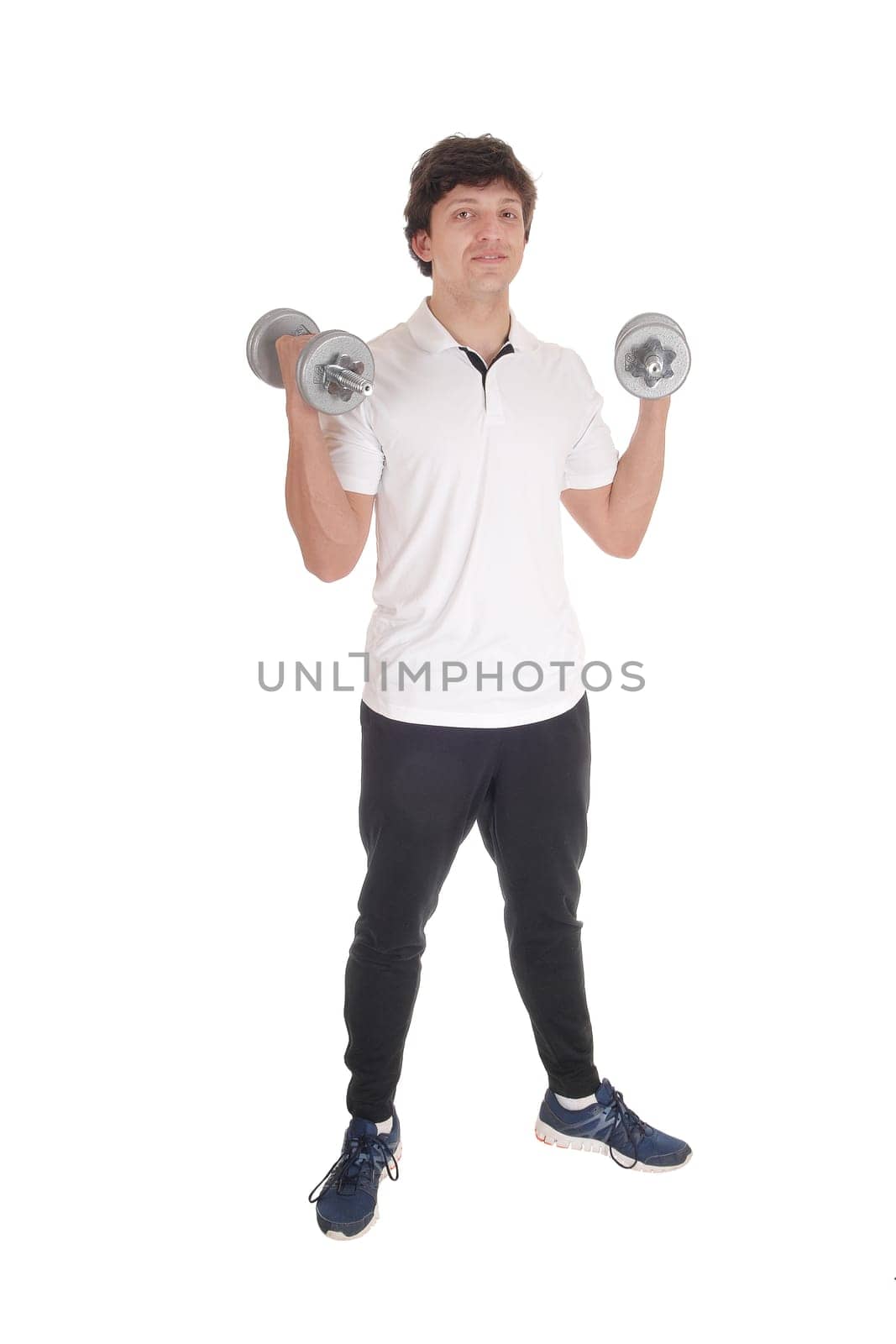 A lull body image of a young Caucasian man standing in exercise outfit holding.two dumbbells, isolated for white background.