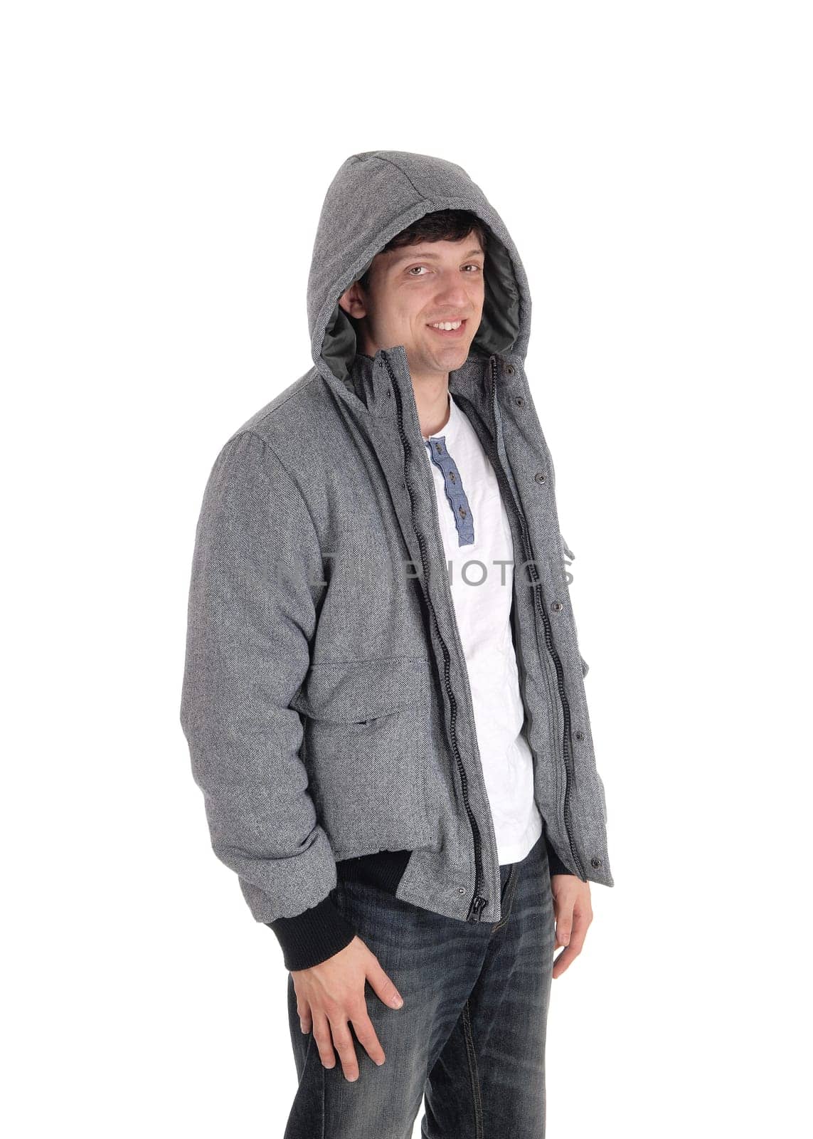 Handsome young man standing halve length in a gray jacket with a hoody and.jeans, isolated for white background.