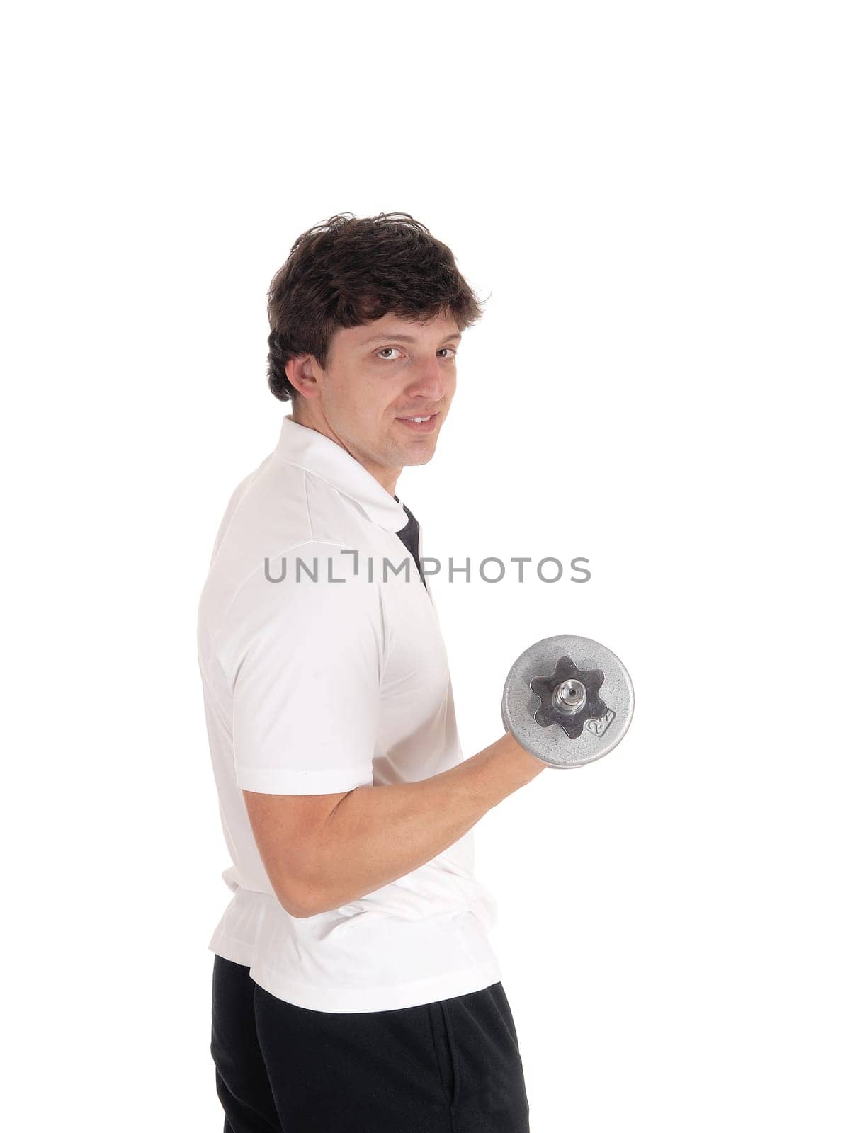 A handsome young Caucasian man standing in profile and close up in a white.shirt, holding a dumbbell, looking into camera, isolated for white background.