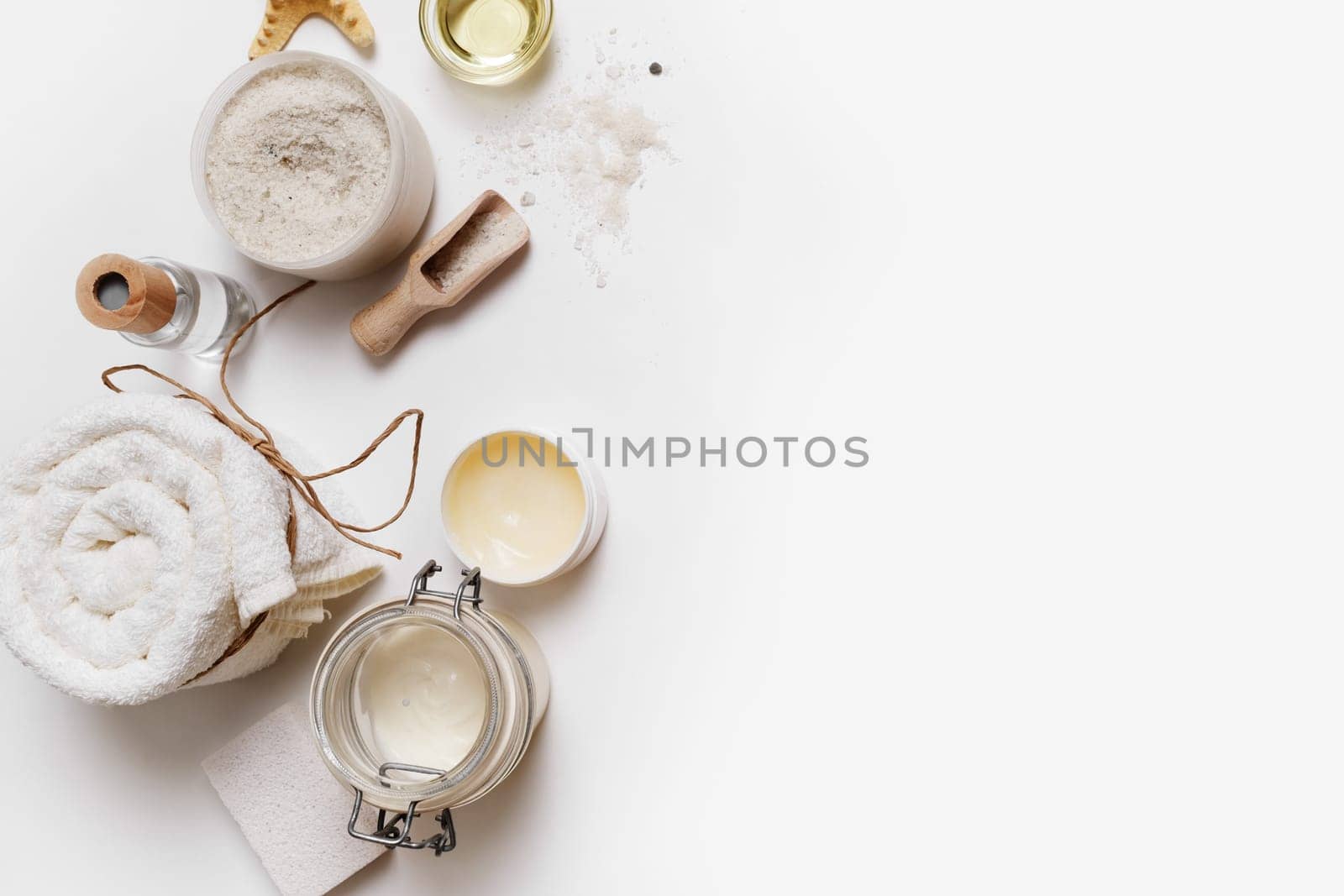 Spa cosmetic background. Treatment products on white paper background. Space for text. Flat lay. Top view.