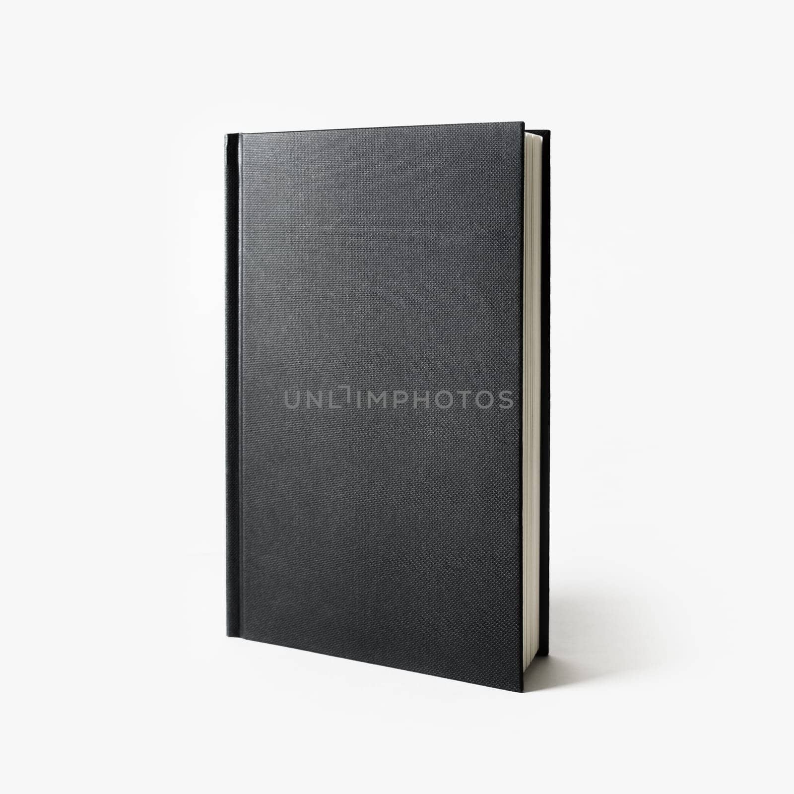 Blank black vertical book cover on white paper background.