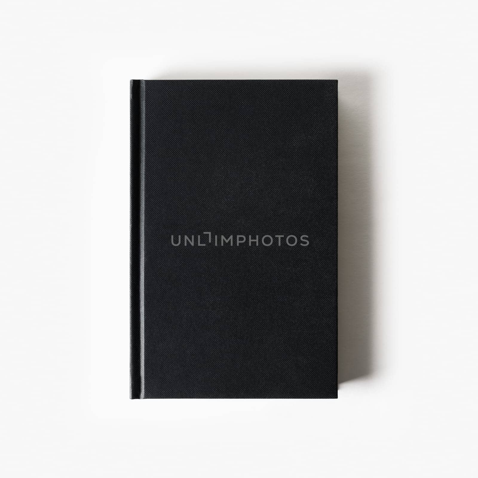 Blank black booklet. Vertical book cover on white paper background. Flat lay.