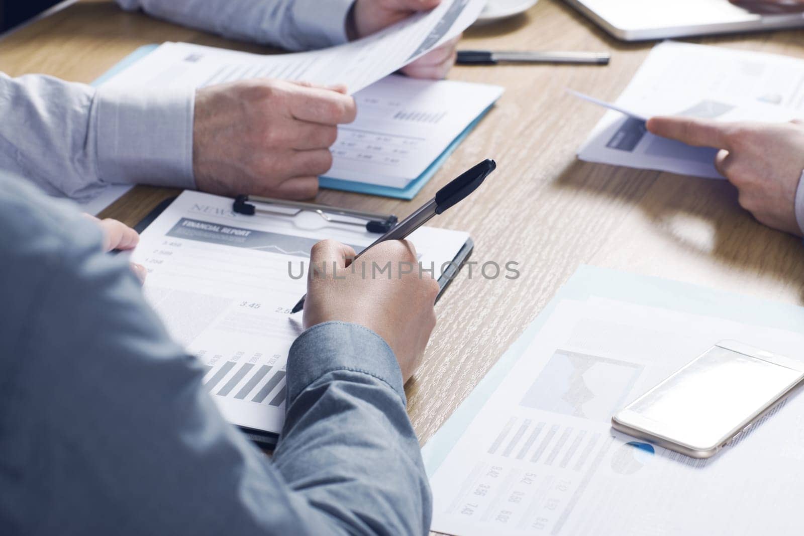 Business people team working together at office desk with financial data and paperwork, teamwork concept