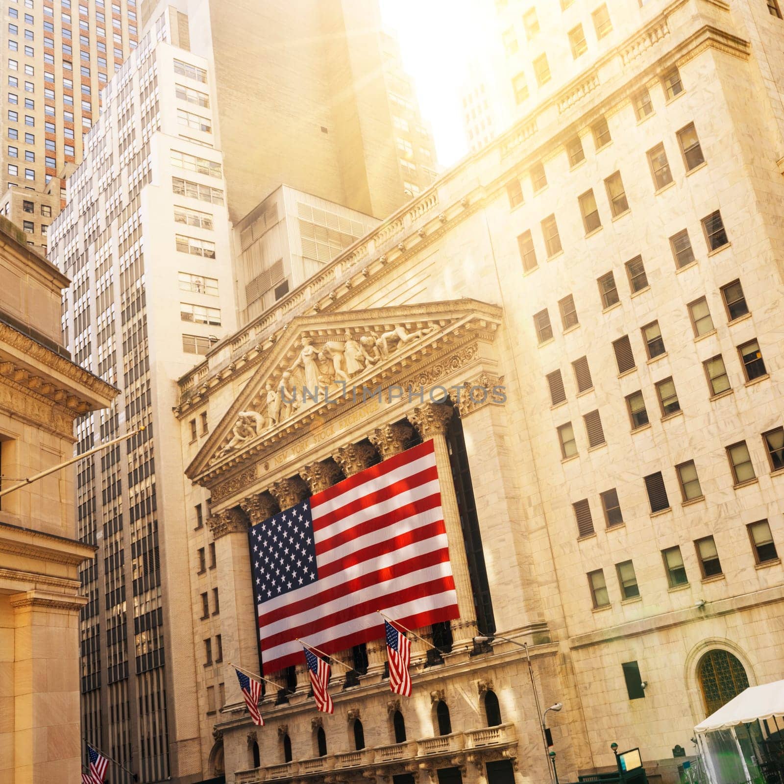 Famous Wall street and the building in New York, New York Stock Exchange with patriot flag