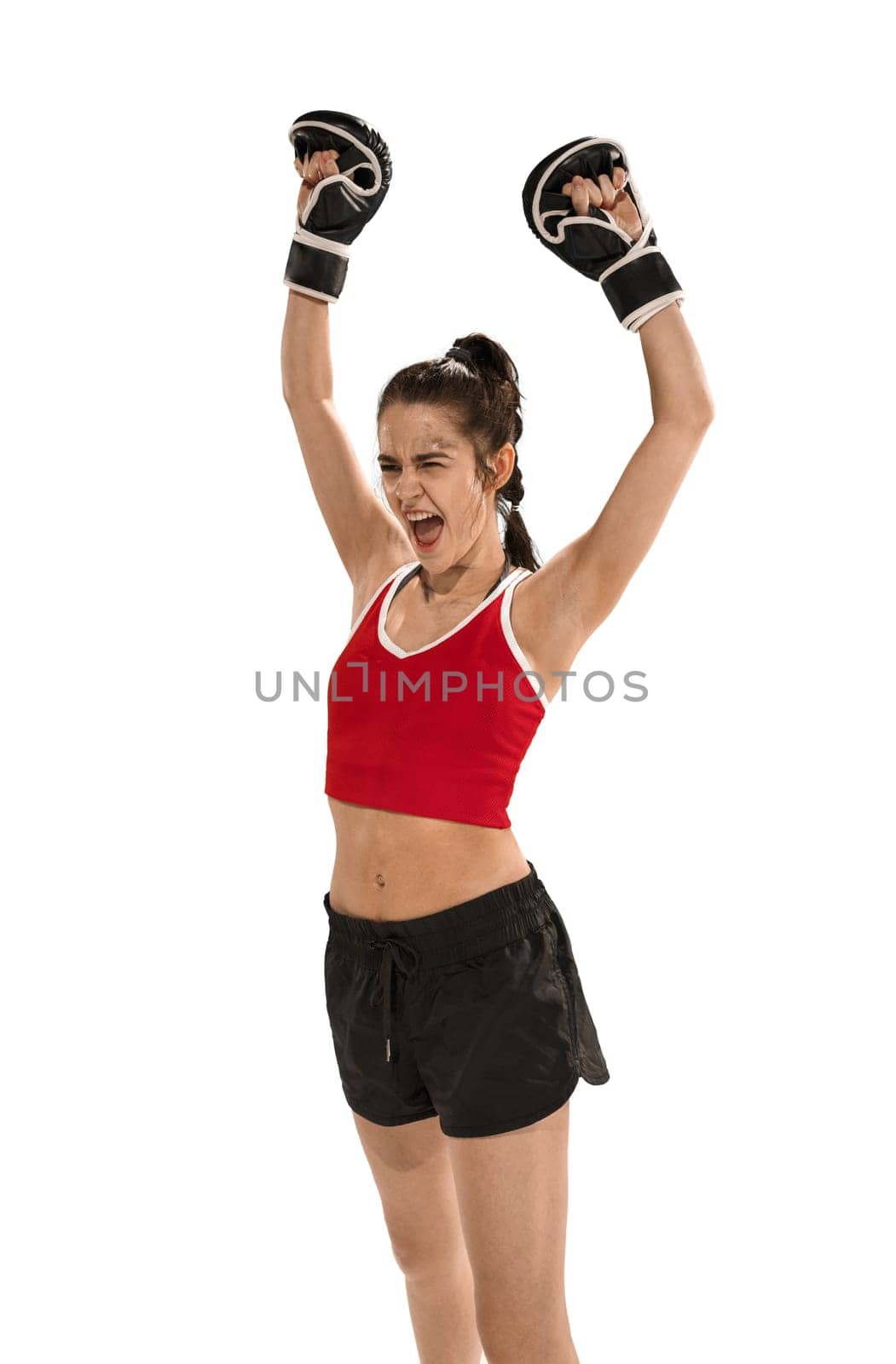 Young active beautiful woman with the black boxing gloves boxing at studio isolated on white background. Fitness, boxing concept. Female boxer. Human emotions. Caucasian model. win, victory, winner concept