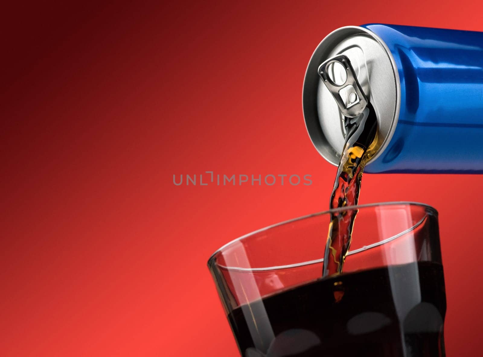 Pouring a refreshing sugary soft drink from a can into a glass