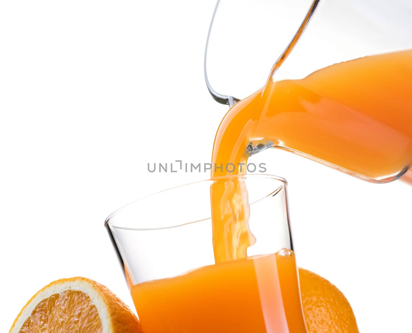 Pouring refreshing natural orange juice into a glass: nutrition and healthy drinks