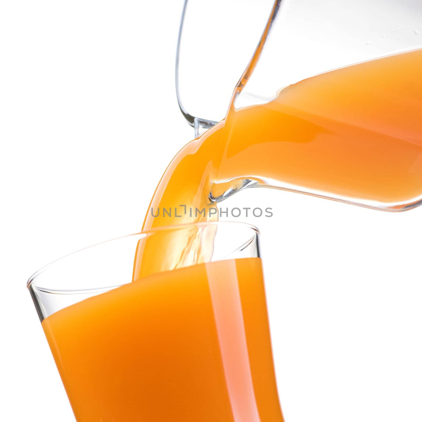 Pouring refreshing natural orange juice into a glass: nutrition and healthy drinks