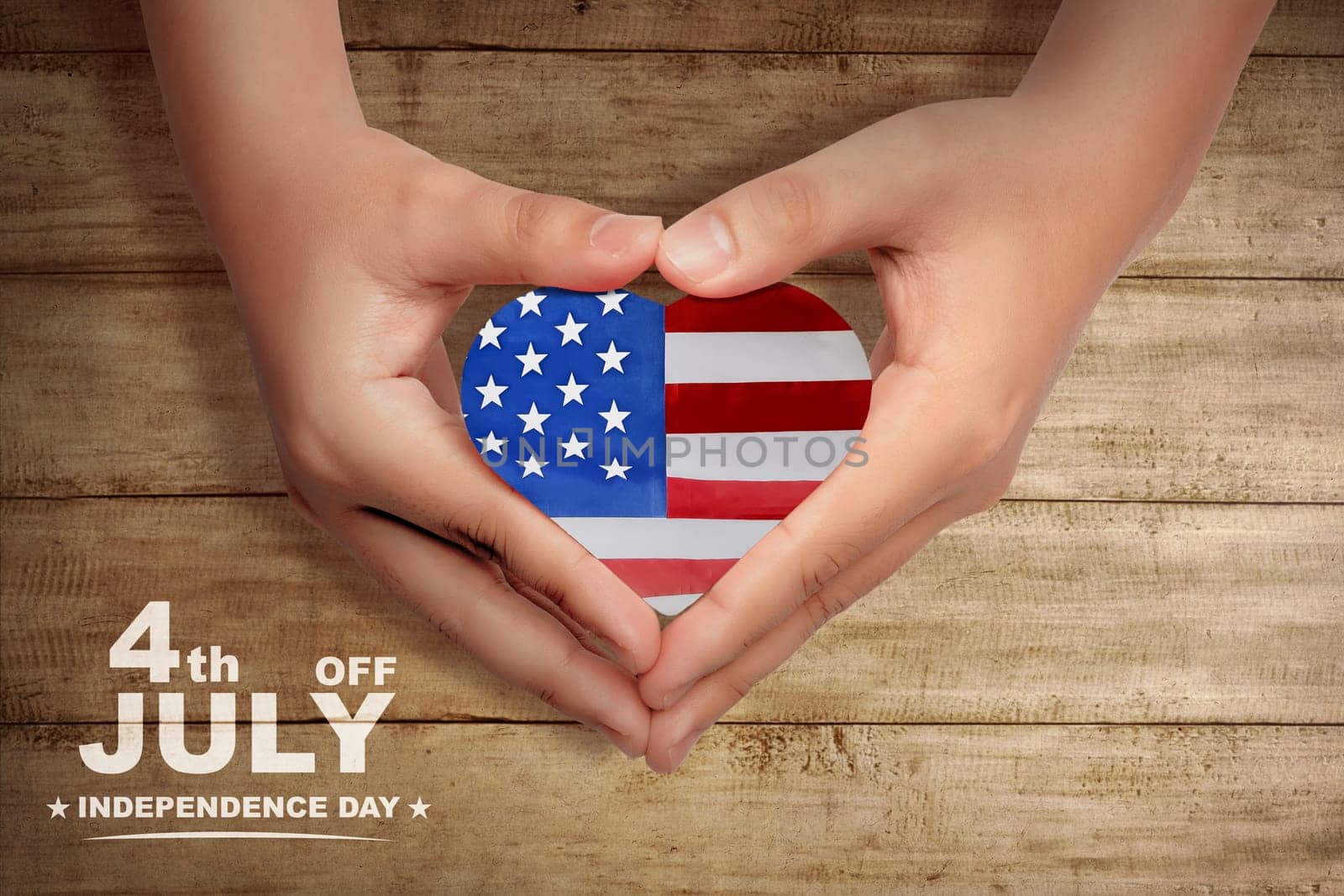 Human hands make a heart shape with american flag inside it. Happy Independence Day