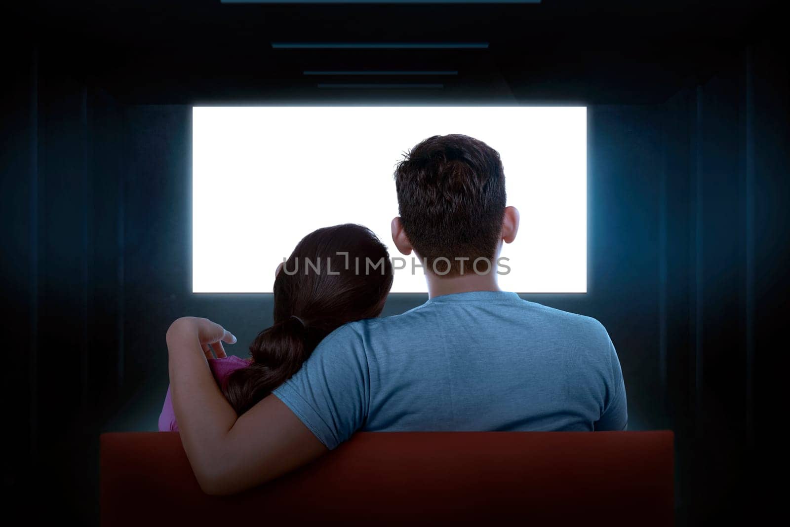 Portrait of asian couple sitting on couch watching blank tv at home