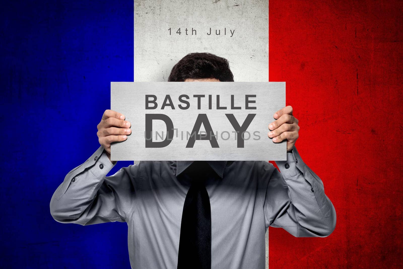 Man holding board with bastille day message over france color flag background