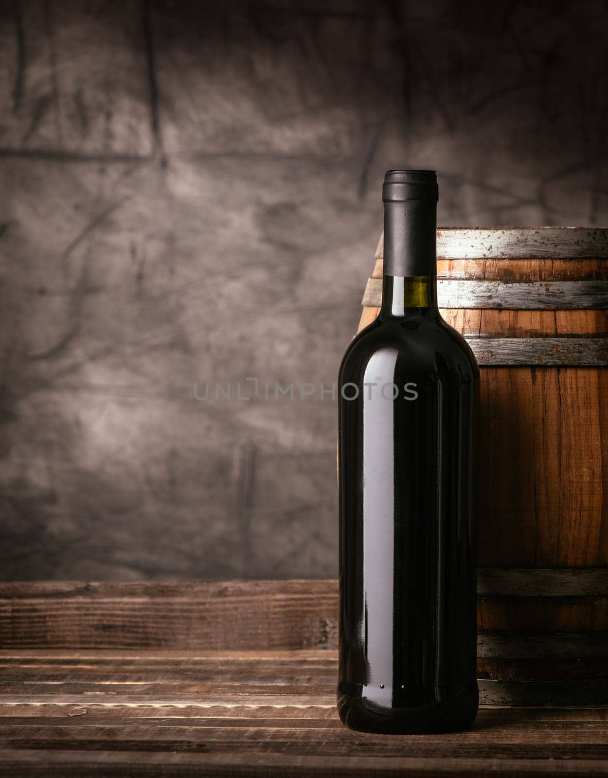 Red wine bottle and wooden barrel in the cellar, traditional wine making and tasting concept