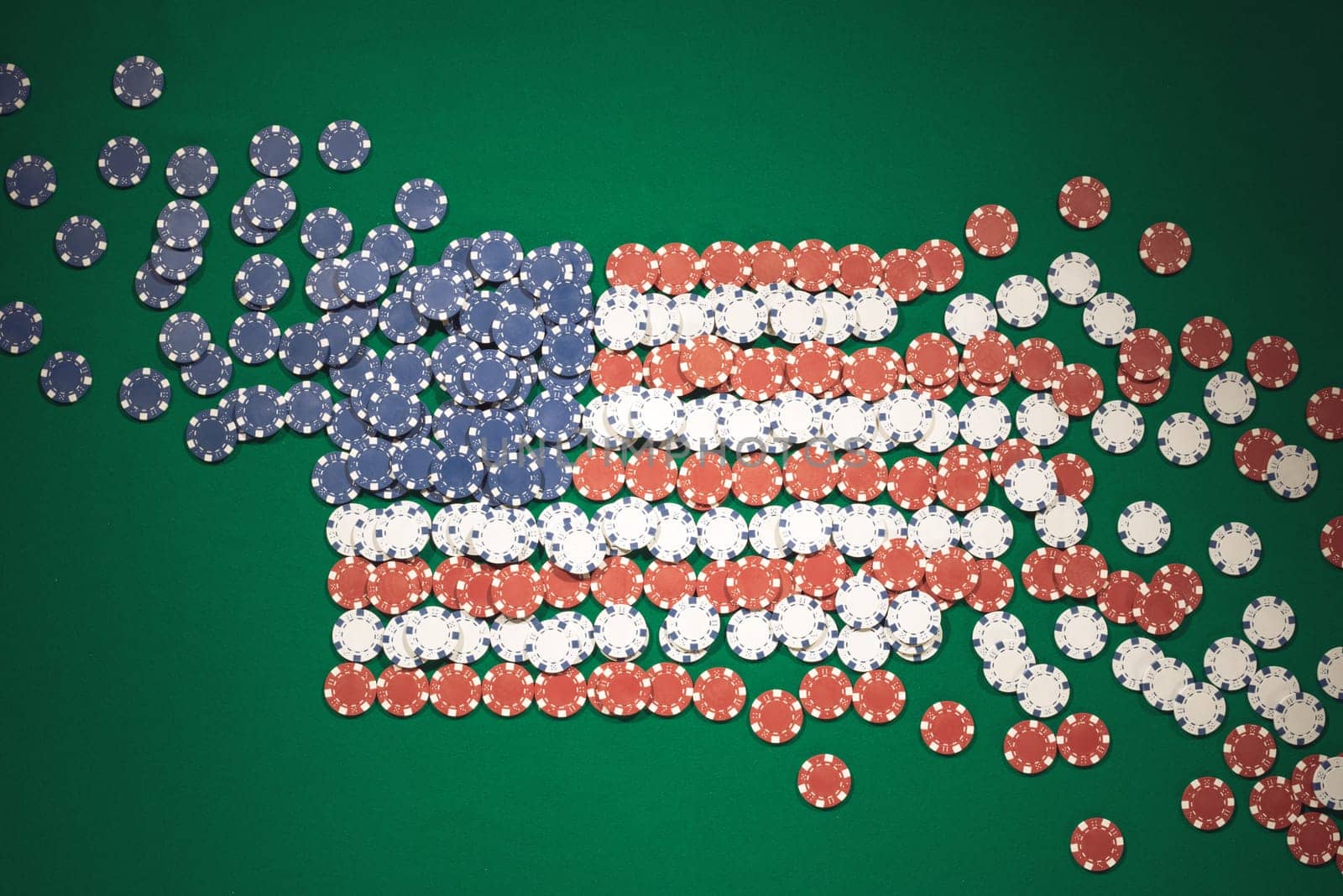 American flag composed of chips on a green table top view, casino and gambling concept