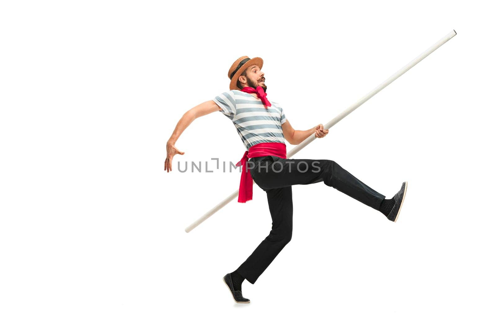 Caucasian funny bearded man in traditional gondolier costume and hat with paddle wide-reaching or jumping at studio isolated on white background. Humor. Human emotions, facial expression concept