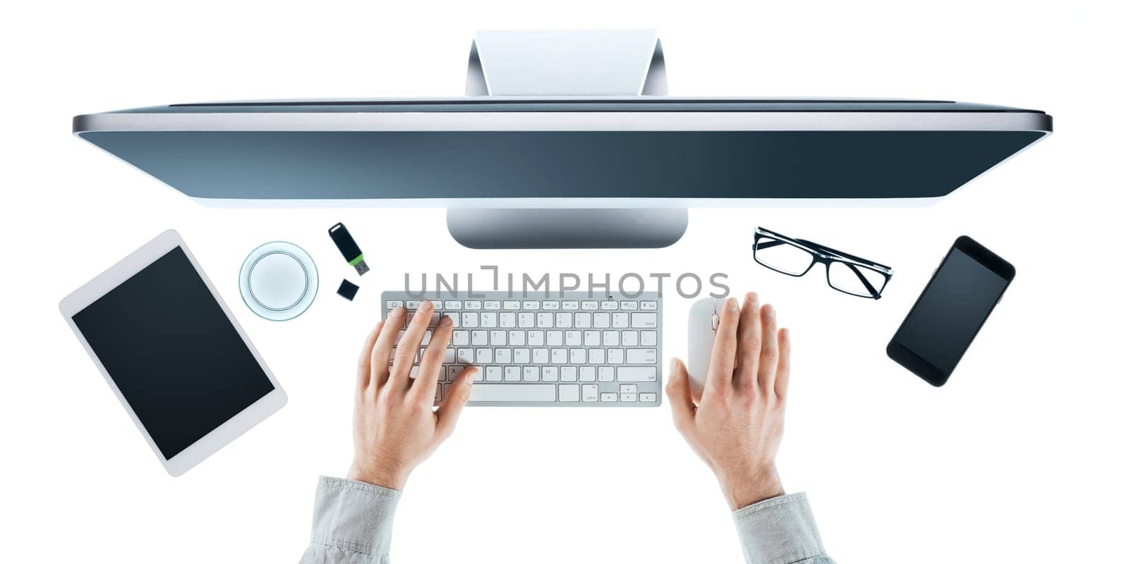 Businessman working at computer at office desk, hands close up top view, white background