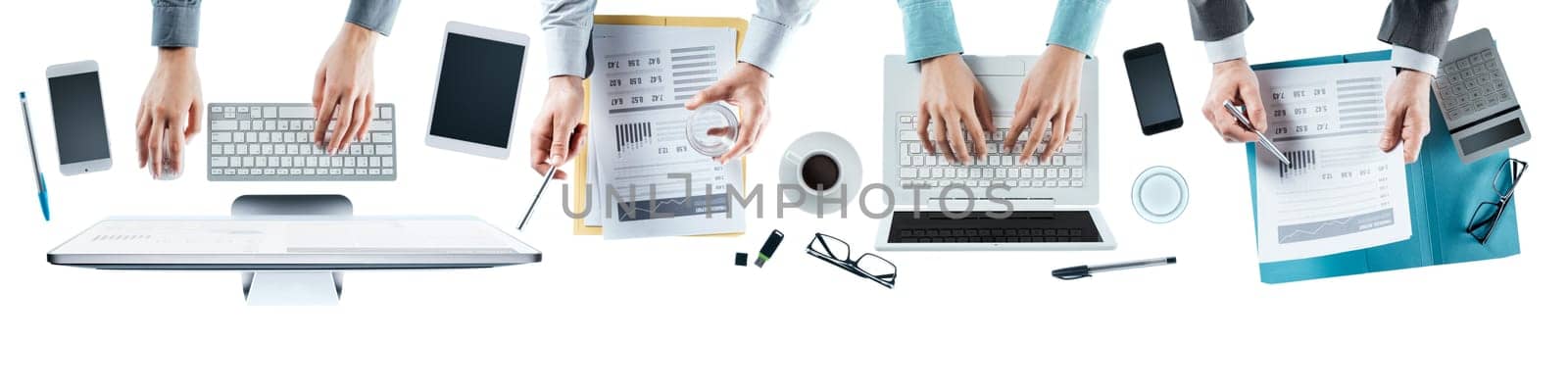 Business team working at office desk top view, blank copy space, unrecognizable people