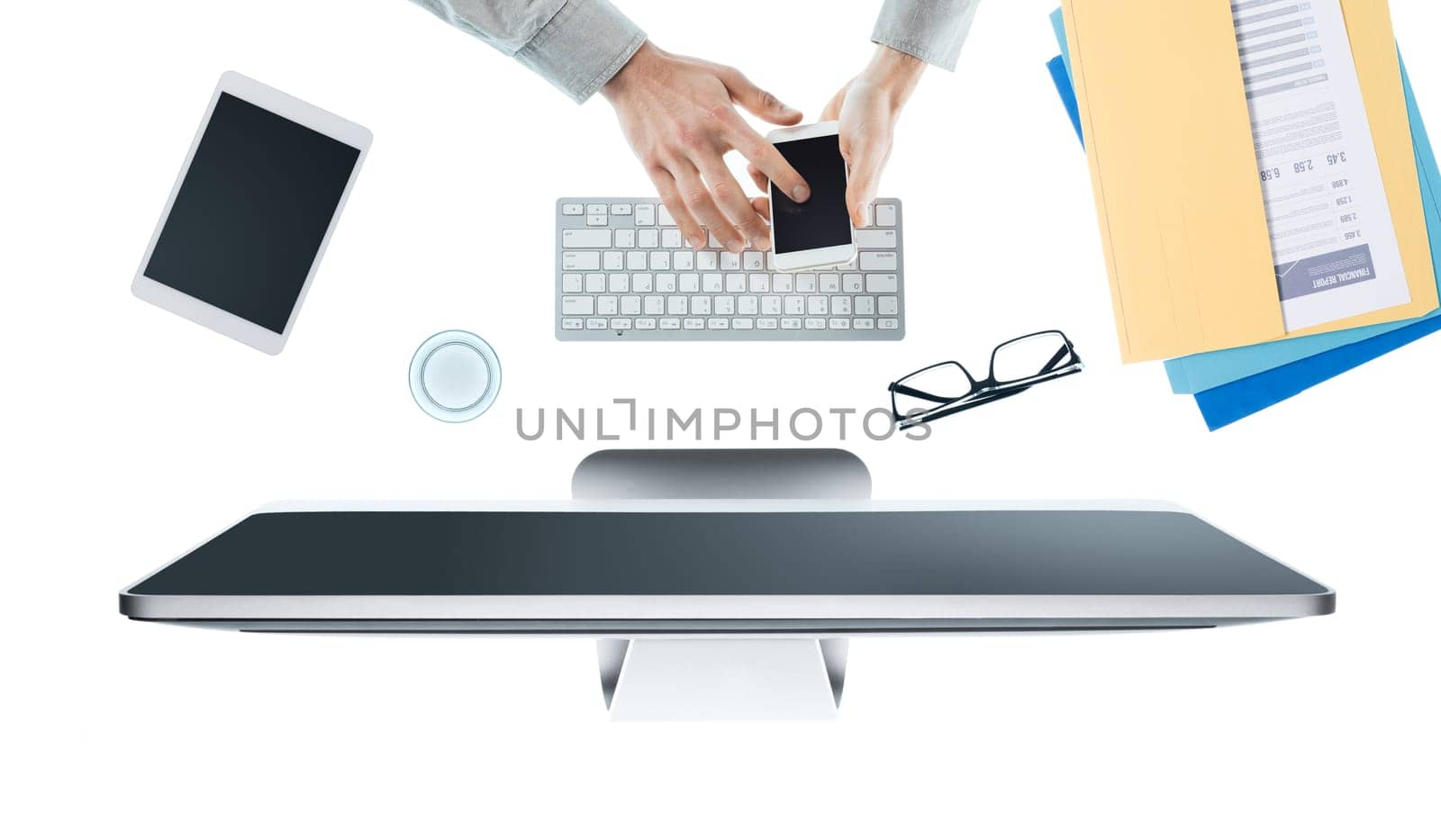 Businessman working at office desk and using an app on a touch screen smartphone, hands top view, white background