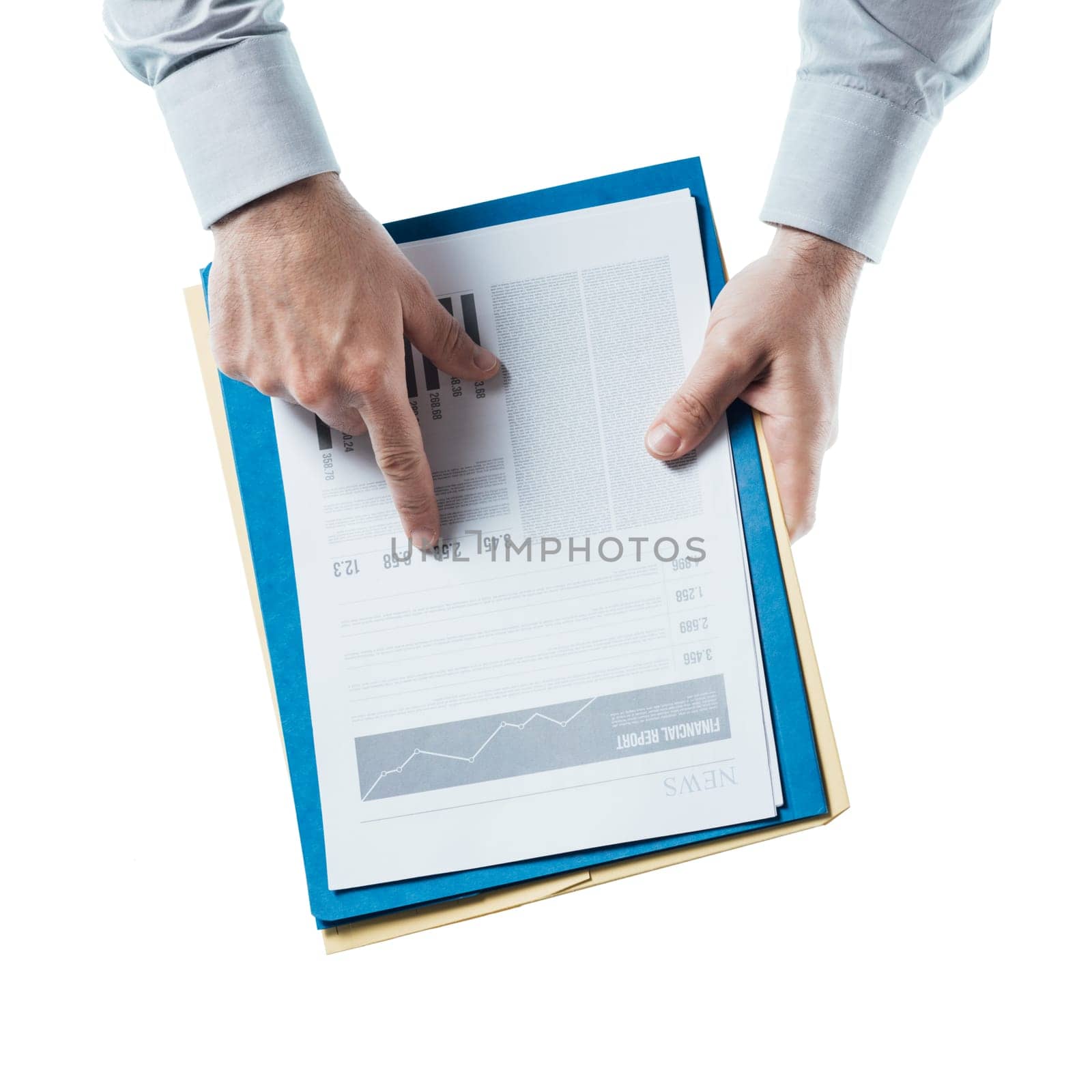 Businessman holding a financial report and pointing at at number, hands close up, top view
