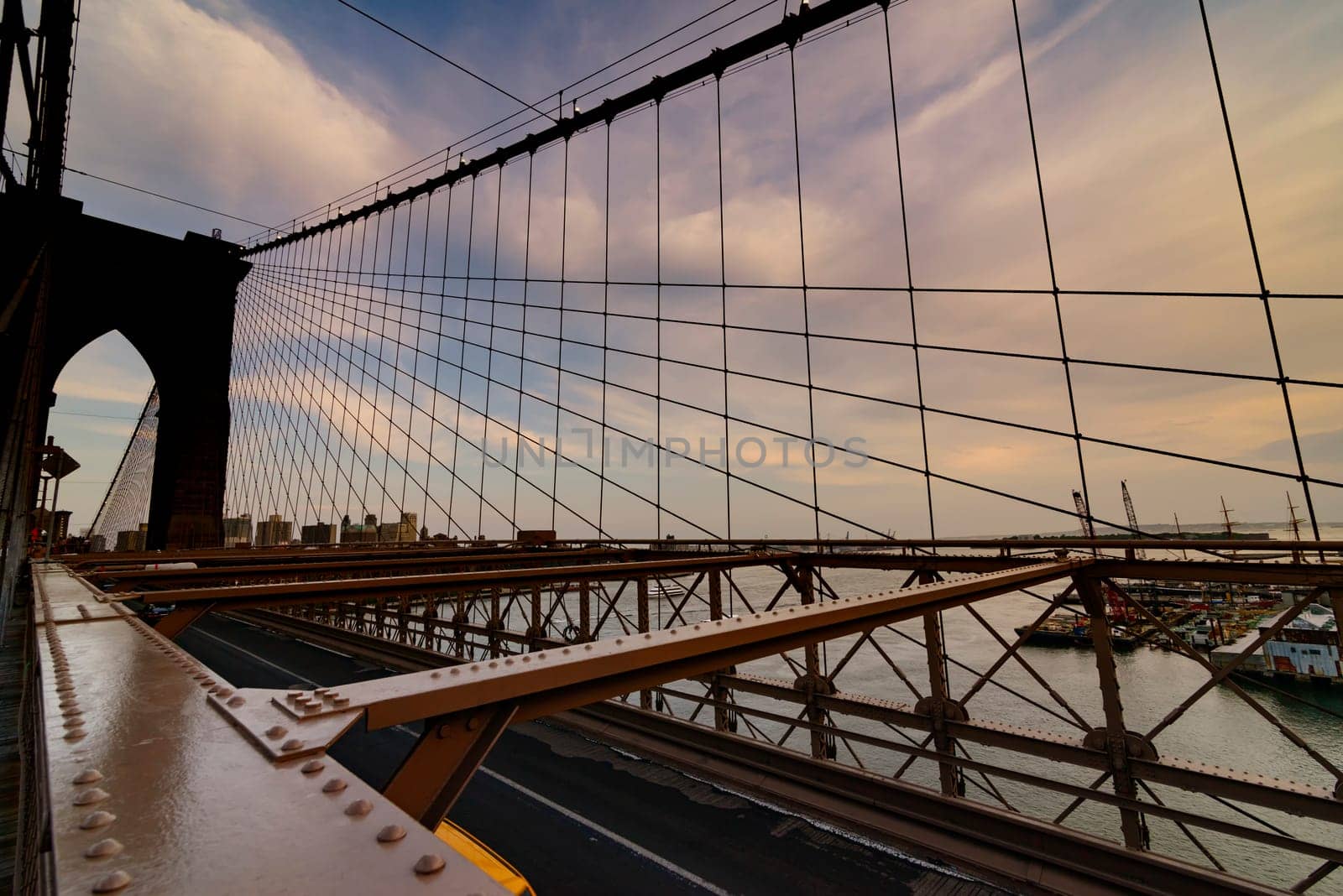 Brooklyn Bridge, New York, United States - June 08, 2015: Panoramic views from brooklyn bridge, skyscrapers and passing cars, the Manhattan skyline.