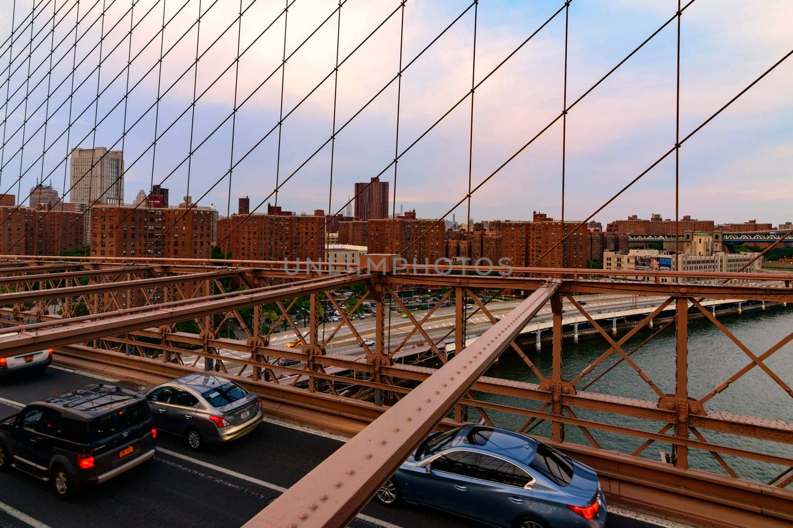 Brooklyn Bridge, New York, United States - June 08, 2015: Panoramic views from brooklyn bridge, skyscrapers and passing cars, the Manhattan skyline.