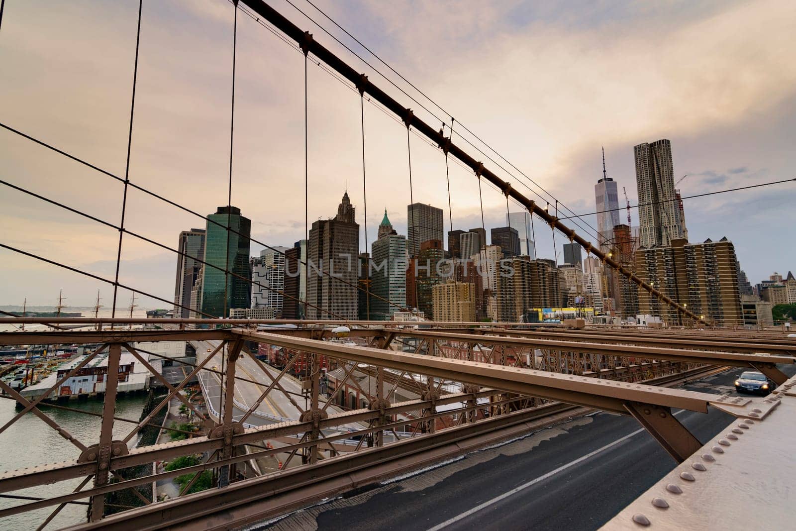 Brooklyn Bridge, New York, United States - June 08, 2015: Panoramic views from brooklyn bridge, skyscrapers and passing cars, the Manhattan skyline.