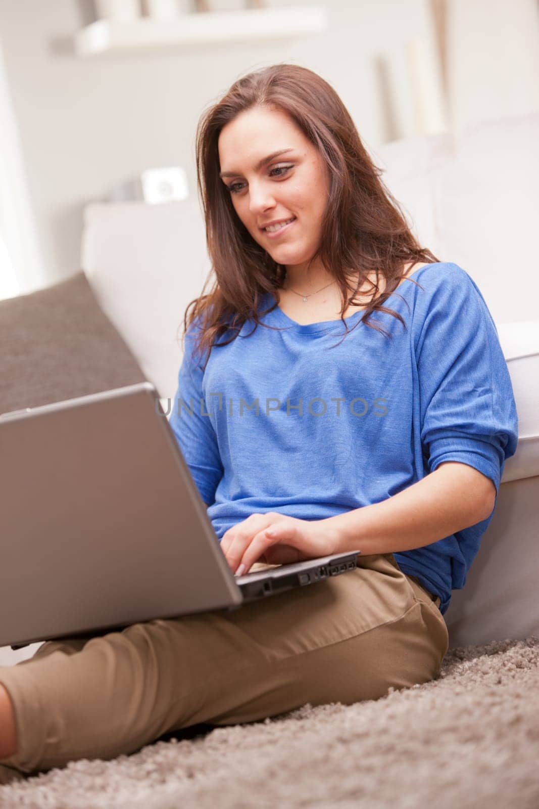 this beautiful self confident girl uses her notebook in relax in her living room