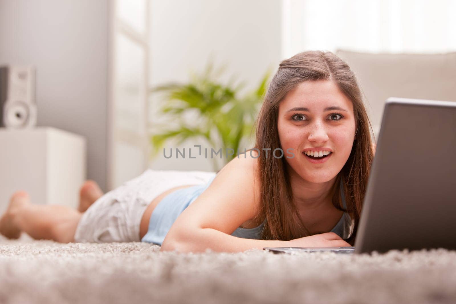 an astonished beautiful girl reading something in her notebook