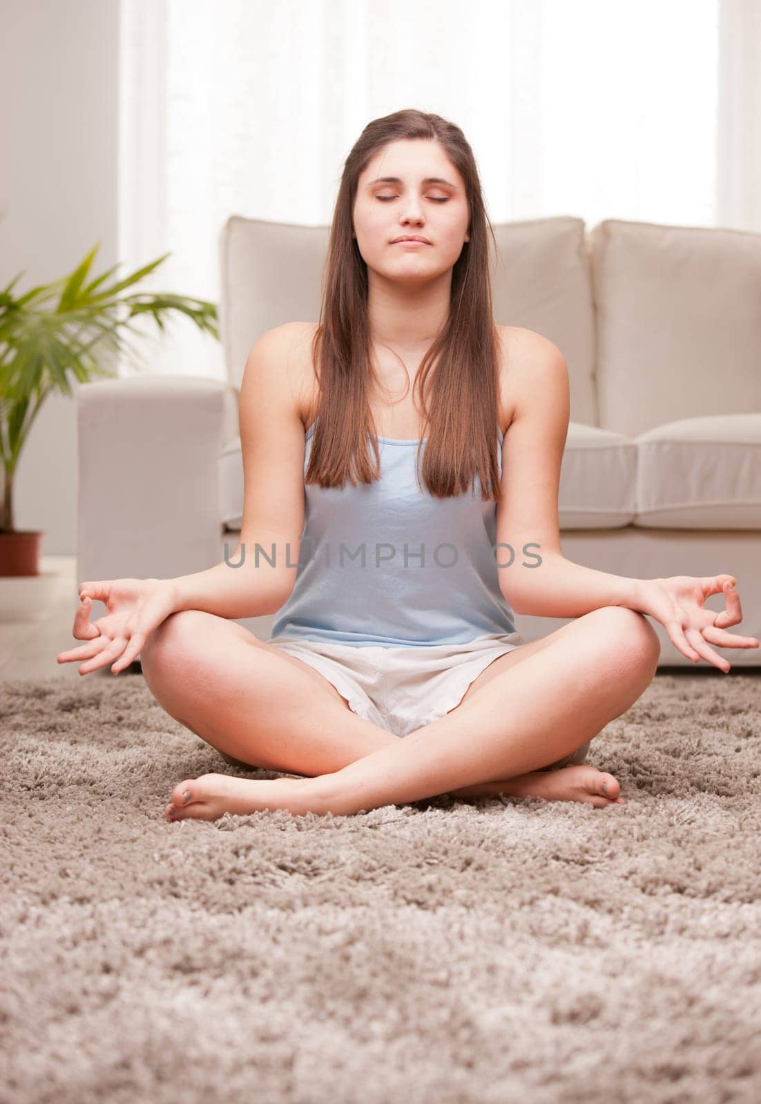 young woman preparing for her yoga exercises