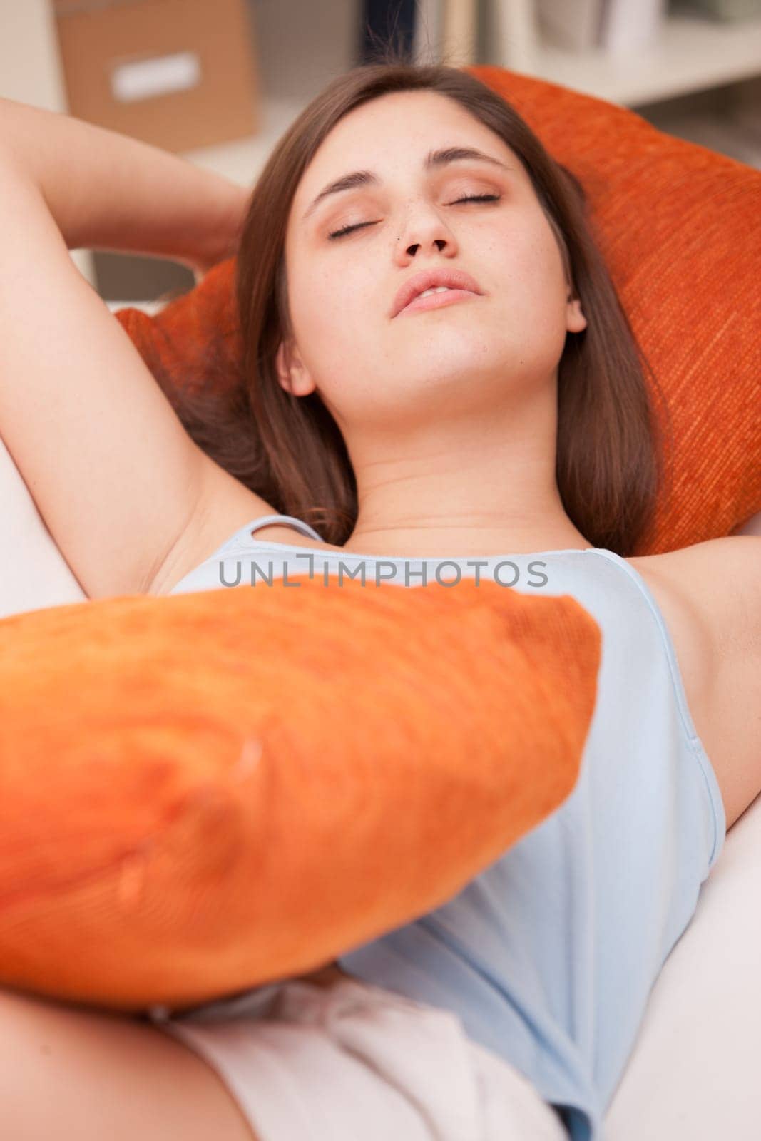 beautiful girl sleeping on her sofa in her living room like a sweet angel
