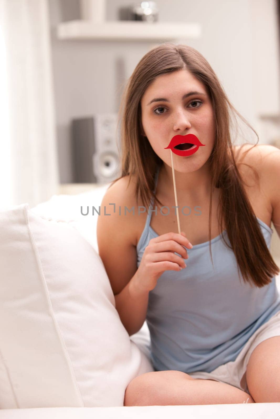 a girl joking with false carton red lips