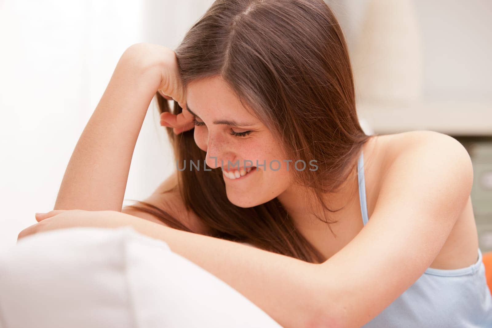 beautiful girl smiling shy on her sofa in her shiny living room