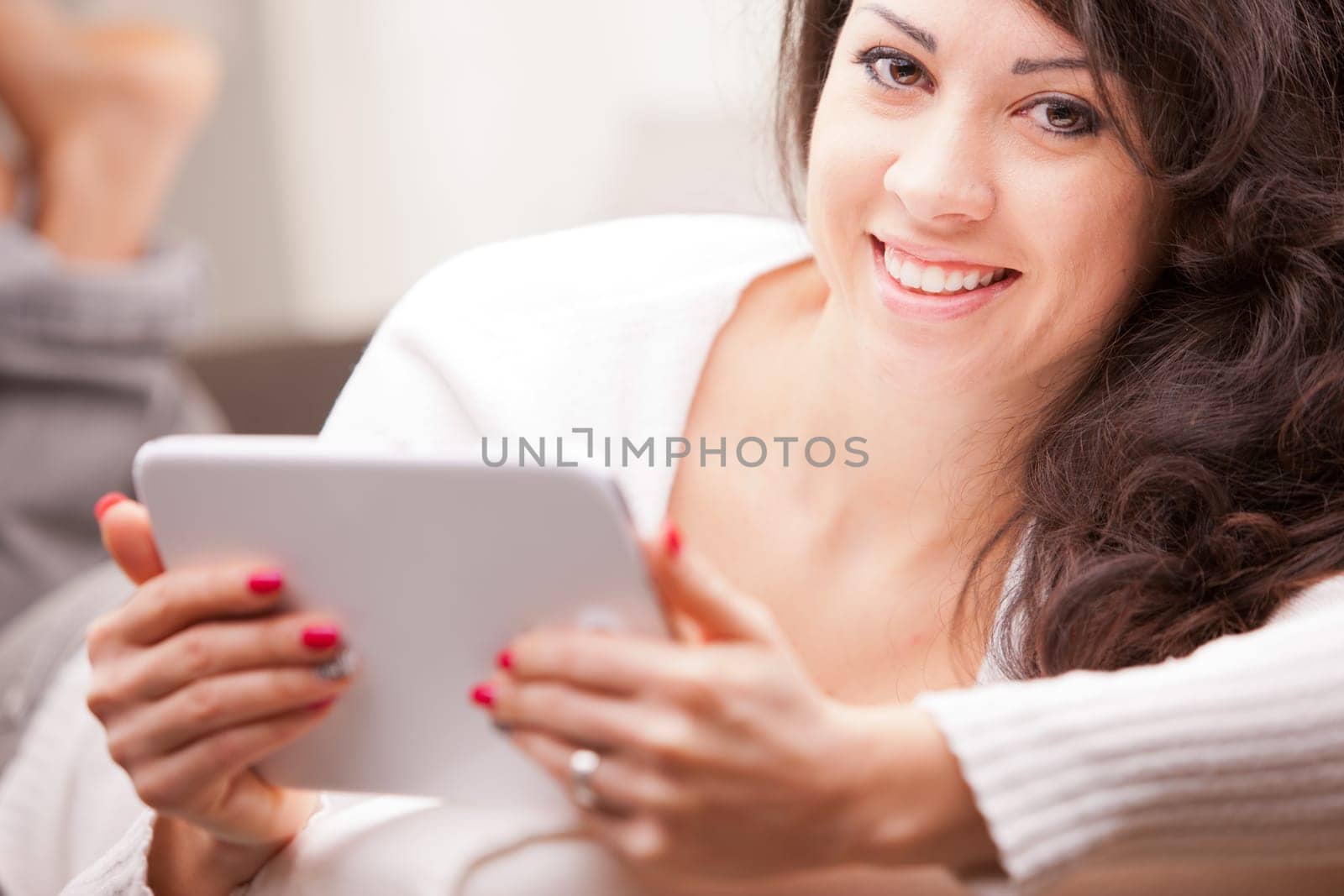 woman reading news in her living room until time to work comes