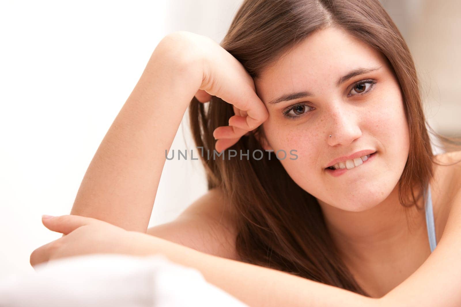 beautiful girl smiling shy on her sofa in her shiny living room