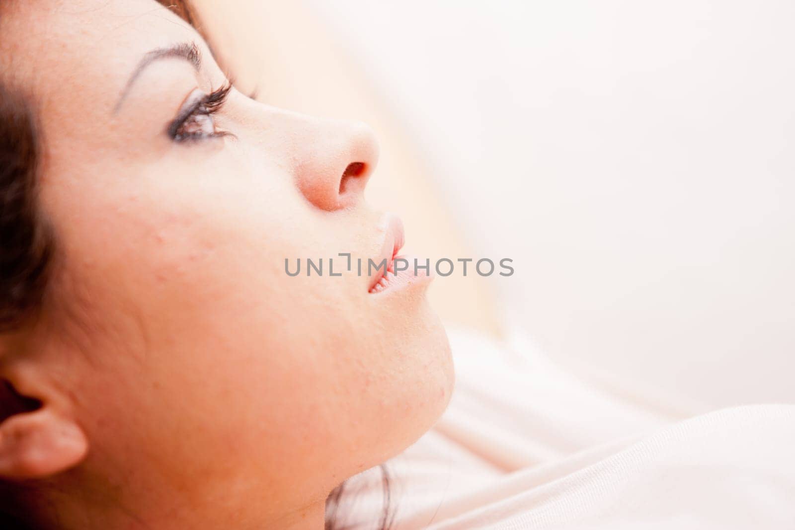 young wonderful woman relaxing on the sofa in her living room and thinking about her problems or the future or her love to come