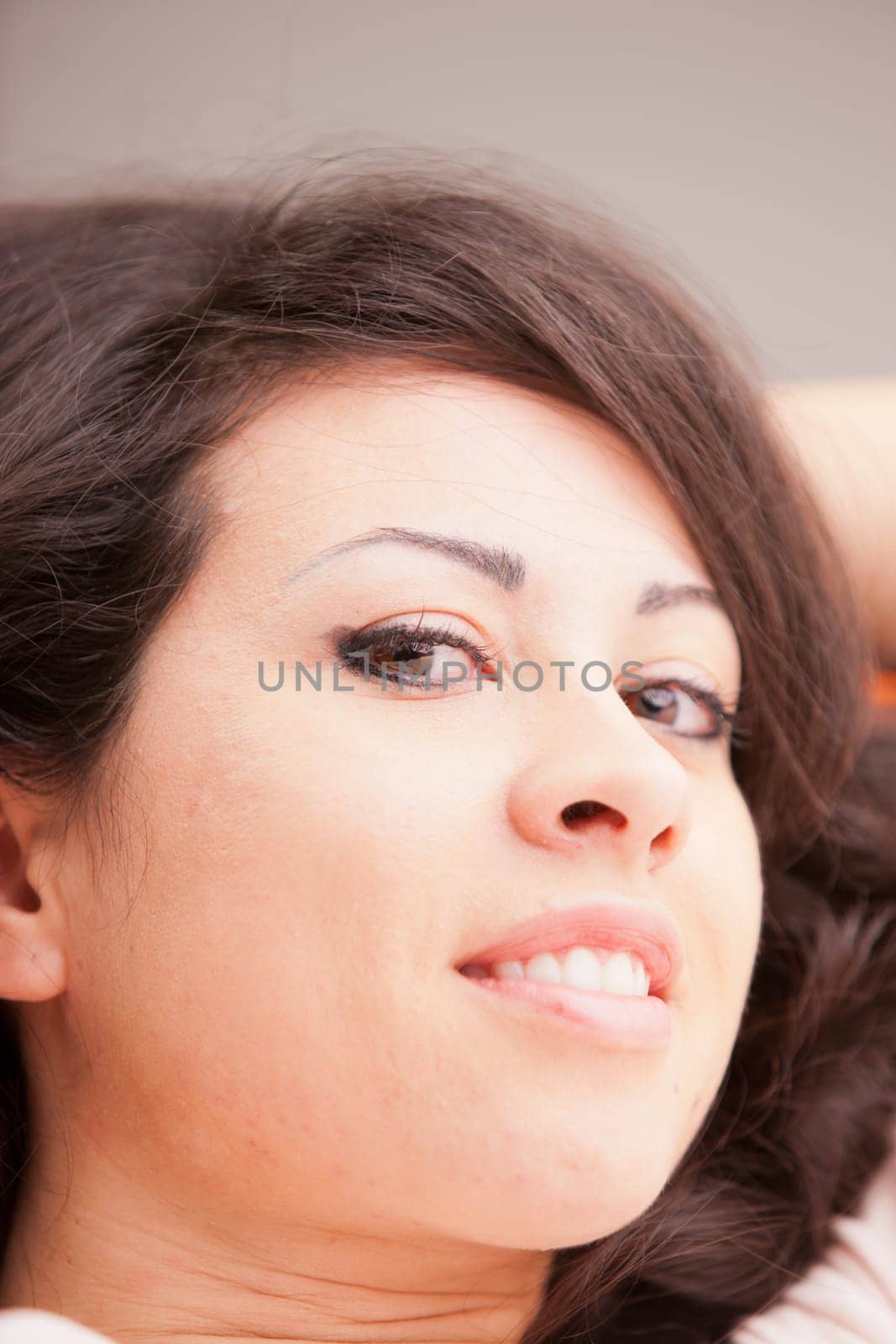 this Italian brunette has big brown eyes and is softly relaxing on this white living room waiting for your AD to be completed