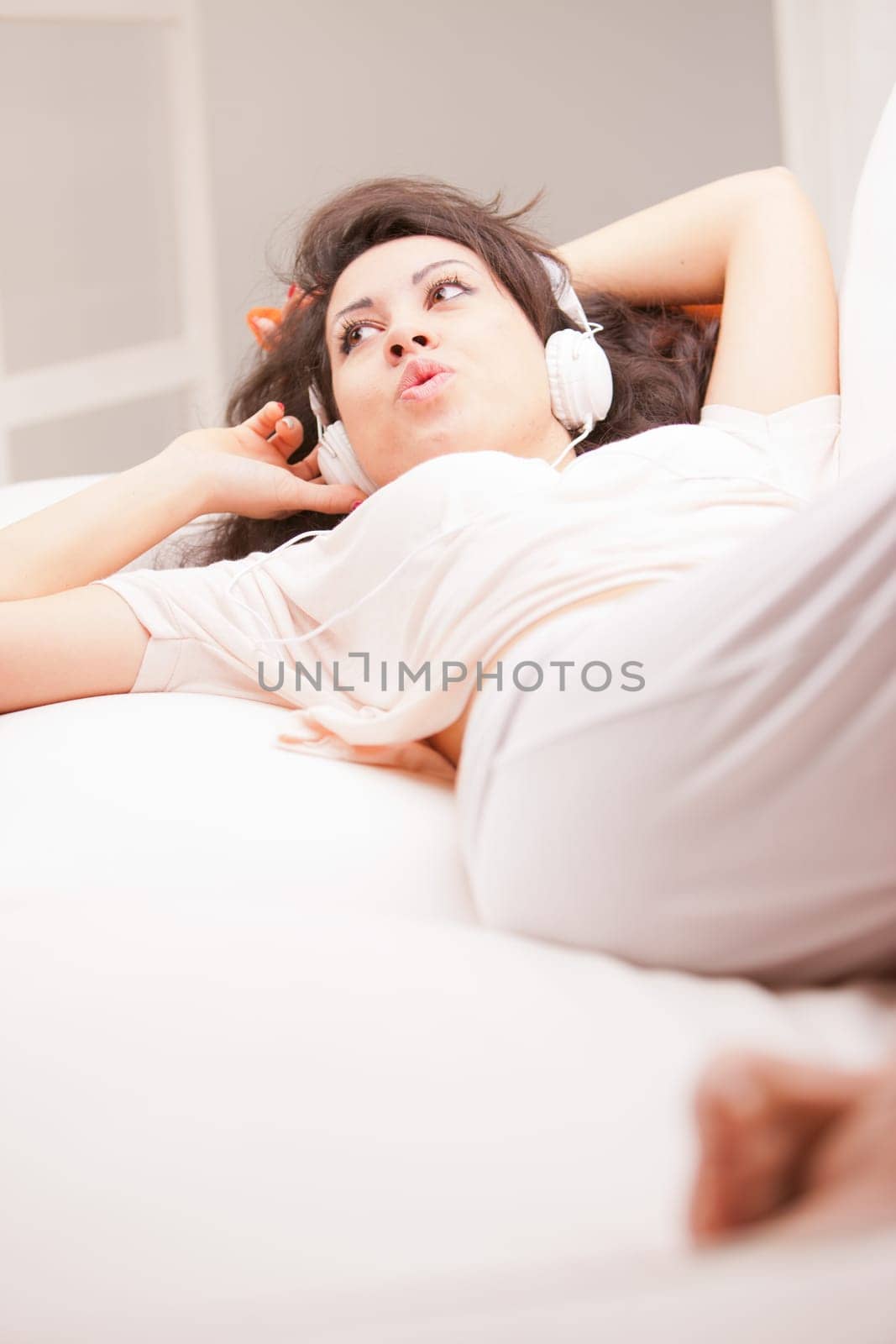 girl listening to music in her house dancing and singing happily in her living room