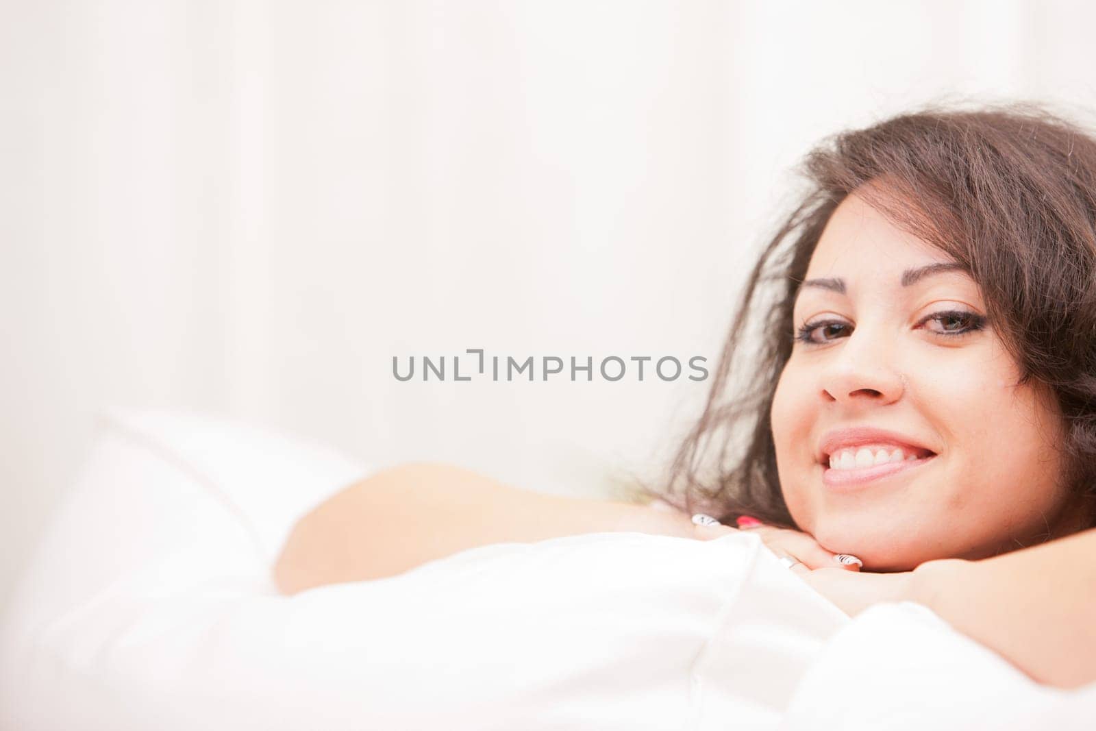 this Italian brunette has big brown eyes and is softly relaxing on this white living room waiting for your AD to be completed